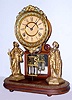 C.1880, Ansonia, CRYSTAL PALACE, No. 1, Extra, 8-day time and strike clock mounted to a walnut splat and base, with cast and gilt figures to the right and left, under a glass dome.