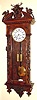 C.1970, German, Lenzkirch, Regulator No. 321, Hunting Motif wall clock, profusely carved with deer head, pheasant, rabbit, percussion rifle, powder horns, mini ball (bullet) holders, bow, arrows and quiver.
