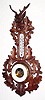 C.1890, German, Aneroid Barometer / thermometer in a nicely carved walnut case of oak leaves, deer head at top and shield at bottom.
