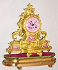 C.1890, French, Howell and James, Paris, Ormolu figural clock with pink shaded panels with paintings of cherubs.