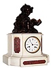 C.1890, French, Patinated Spelter and Marble clock, 8-day bell strike, surmounted by a cherub at a grape festival, with a crown of grape leaves and an empty chalice in his right hand, and a happy look on his face.
