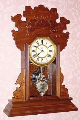 C.1893 Waterbury Clock Co., "Norwalk", 8-day time and strike mantel clock, in walnut, less glass. — Antique Clocks Price Guide