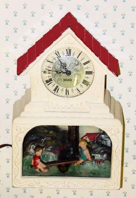 C.1948, Haddon Products, Inc, Chicago, Ill, 110v, THE TEETER TOTTER, electric timepiece with lighted animation below dial. — Antique Clocks Price Guide