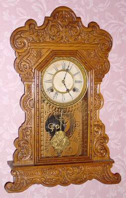 C.1906, Waterbury Clock Co., "Felix" , 8-day time and strike oak gingerbread clock. — Antique Clocks Price Guide