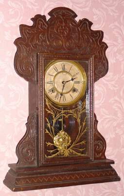 C.1906, Waterbury Clock Co., "Harlem" , 8-day time and strike walnut gingerbread clock. — Antique Clocks Price Guide