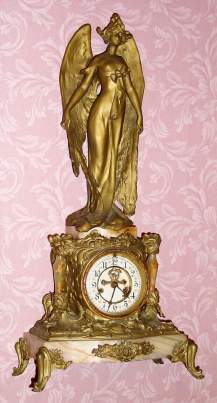 C.1900 Waterbury Clock Co., [?] figural clock, iris theme, 8-day time and gong strike onyx and cast white metal. — Antique Clocks Price Guide