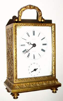 C.1890, French, Novelty Travel Alarm, (pivoted pendulette movement) in a gold painted white metal case with embossed brass rear cover that slides up for winding and setting the hands. — Antique Clocks Price Guide