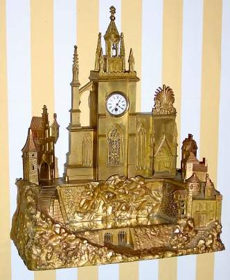 Mid 19th Century, French or Swiss, Clock in the form of a Cathedral complex, a mirrored pond in front of the church, formerly with music box, now absent. — Antique Clocks Price Guide
