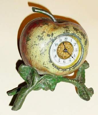C.1900, Waterbury Clock Co., APPLE TIMEPIECE , one day novelty. Cast metal apple is hinged in the center, and opened to wind and set the movement. — Antique Clocks Price Guide