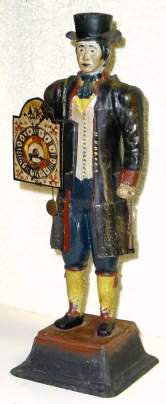 C.1975, German, Pot Metal CLOCK PEDDLER with working 1-day clock held in the front, an inanimate clock on his back, the 2 clock weights in his left hand. — Antique Clocks Price Guide