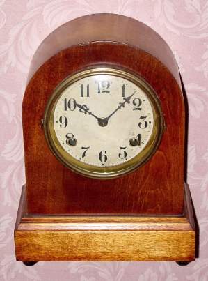 C.1917, Waterbury Clock Co., Birch cased price leader Round Gothic mantel clock, 8-day time and strike. — Antique Clocks Price Guide