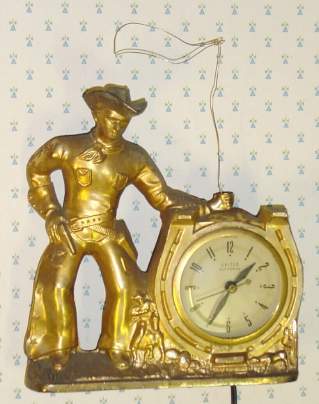 C.1940, United Electric Clock Corp, Brooklyn, NY, COWBOY, 110v, timepiece, cast metal cowboy, with rotating lasso turning on top of the clock. — Antique Clocks Price Guide