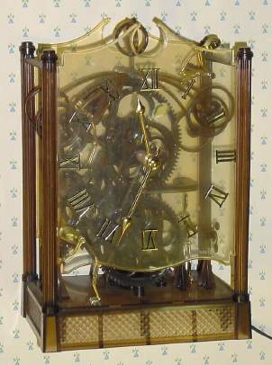 C.1978, Arrow Industries, Penrose, CO, MASTER MOTION, 110v, electric clock, with 4 gilded plastic "men" appearing to crank out the time. — Antique Clocks Price Guide