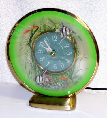 C.1930, Sessions Clock Co., Forestville, Conn, AQUARIUM , 110v, timepiece with angel fish appearing to swim around the clock in the center. — Antique Clocks Price Guide
