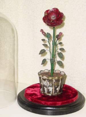 C.1890, French, Flower Clock, rare motif, with central petals revolving as the minutes, indicated by a tiny brass bug, next petal ring revolving as the hours, indicated by a fluttering insect of brass, and the numerals delicately painted on the outer 12 petals. The movement is contained within the flower pot, unsure of duration, but at least one day, perhaps more. — Antique Clocks Price Guide