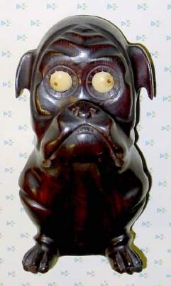 C.1928, German, Oswald, Large Carved Wood BULLDOG, dark stained finish, larger size eyes; time indicated by position of the pupil. — Antique Clocks Price Guide