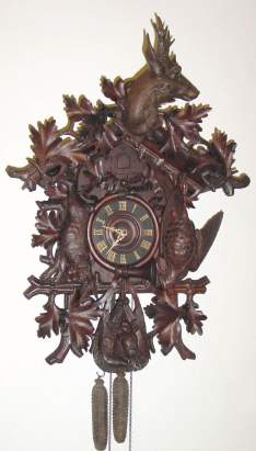 C.1915, German, Large Cuckoo clock, Hunting motif , with side carving of deer's head, rabbit pheasant and profuse oak leaves and acorns. — Antique Clocks Price Guide