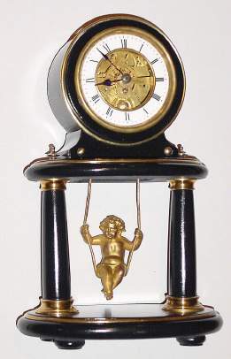C.1880, French, Farcot, Swinging Doll timepiece, in a black marble case with brass trim, unusual oval portico design. — Antique Clocks Price Guide