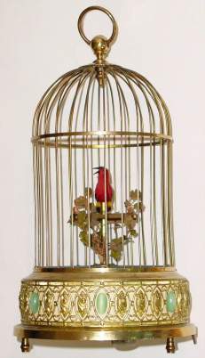C.1955, German, Singing Bird in Cage, bird with red feathers, bottom wind, with start/stop lever; bird turns and flutters when singing. — Antique Clocks Price Guide