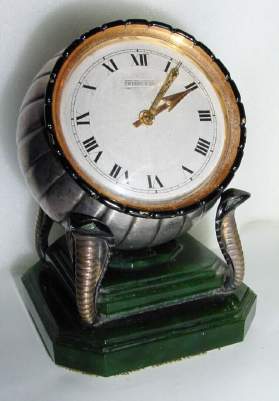 C.1955, Swiss, Zenith Watch Co., for TIFFANY and CO., round, rim wind, desk clock with its original "4-Cobra" stand, brass and gilt cobras on a jade base. — Antique Clocks Price Guide