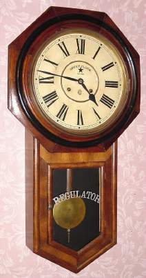 C.1906, Waterbury Clock Co., Waterbury, Conn, CONSORT, 8-day time and strike long drop octagon school clock in walnut. — Antique Clocks Price Guide