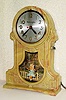  C.1940, Mastercrafters Clock and Radio Co., Chicago, SWINGING DOLL automaton timepiece, 110v, young tow head girl in a swing, ahead of a white picket fence in front of a cottage. 