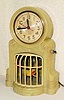  C.1940, Mastercrafters Clock and Radio Co., Chicago, BIRD ON SWING automaton timepiece, 110v, yellow parakeet swinging vigorously swinging in front of a village scene. 