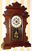  C.1890, New Haven Clock Co., "Coquette" , 8-day time/strike mantel clock in black walnut. 