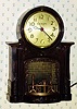  C.1948, MasterCrafters Clock Corp., Chicago, FIREPLACE , 110v timepiece, with bright red fire appearing to burn the fireplace below the dial. 