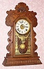  C.1901 Ansonia Clock Co., NY, "Kenmore" , 8-day time/strike/alarm gingerbread clock. 