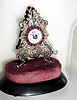  C.1850, Austrian, Zappler 30-hour timepiece, with silvered brass facade (casting), and ruby-like stones around the dial. 