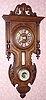  C.1890, French, Clock and Barometer in a walnut cartel style case with carving. 