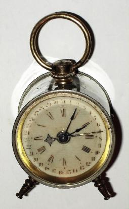 C.1900, Parker Clock Co., Meriden, Conn, Calendar Alarm clock, in a nickeled case with original handle and feet. — Antique Clocks Price Guide