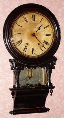 C.1870, Anglo-American, 8-day time/strike round drop school style clock, carved accents with rolling pin bottom and mirror back. — Antique Clocks Price Guide