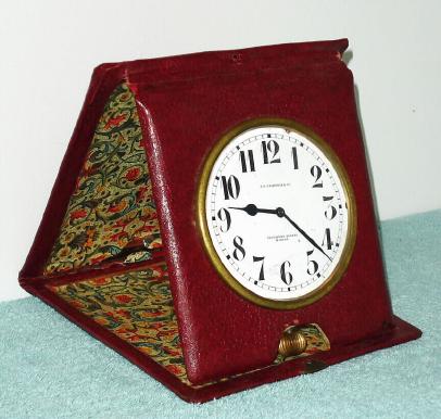 C.1900, Swiss for J. E. Caldwell and Co., 8-Day Quarter Repeating travel clock, in a maroon leather folding travel case. — Antique Clocks Price Guide