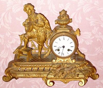 C.1890, French, Gilt Spelter Figural clock, showing a mandolin player in late 18th century costume with sword. — Antique Clocks Price Guide