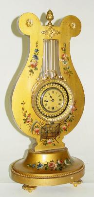 C.1900, French, Gilt Wood Lyre form timepiece with rotating accent ring around the dial, that act as a giant balance, 8-day. — Antique Clocks Price Guide