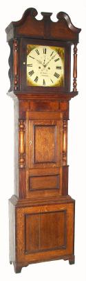C.1840, English, Jn. Hughes, Carnarvon, Square dial tall case, 8-day, in a wide, short door case, with attractive oak and mahogany veneers. — Antique Clocks Price Guide