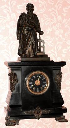 C.1890, French for Tiffany and Co, NY, a bronze and marble tribute to Johannes Gensfleisch zur Laden zum Gutenberg, a quarter chime clock playing Westminster tune on 4 bells suspended beneath the "siamese" style movement. — Antique Clocks Price Guide