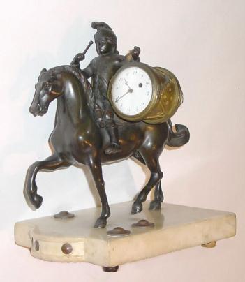 C.1810. French, Bronze on Marble Stand, the clock housed within a bronze drum, carried by a mounted soldier, in dress uniform. — Antique Clocks Price Guide