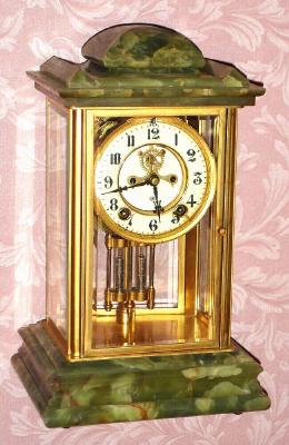 C,1914, Ansonia Clock Co., New York, PREMIER, brass, glass and onyx crystal regulator, 8-day, gong strike, with open escapement on dial. — Antique Clocks Price Guide