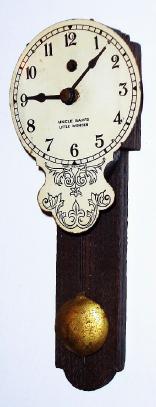 C.1923, (dated label on rear) American, 30-hour pendulette, mini "marble" wall clock, with "Uncle Sam's Little Wonder" printed on the dial. — Antique Clocks Price Guide