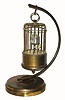 C.1950, German, I. Kaiser Gmgh, Villingen, Bird in Cage, on Stand, with alarm, the time indicated on annular rings (bottom for hours, top for minutes), a separate dial in the floor of the cage for the alarm, and with a twitching bird that moves when clock ticks. 