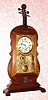 C.1975, Modern Repro of the famous VIOLIN clock. The originals were made by Seth Thomas in the 1890s, see one in Palmer's TREASURY OF AMERICAN CLOCKS, PAGE 259. 
