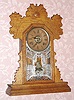 C.1894, Ansonia Clock Co., 8-day time and strike, oak gingerbread kitchen clock. 