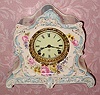 C.1905, Ansonia Clock Co., La Lorne, Royal Bonn china clock in cream color with sky blue accents and pink-yellow floral decorations. 