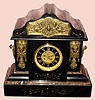 C.1890, French, Black Slate and Bronze mantel clock, 8-day time and gong strike, with open escapement on the dial. 