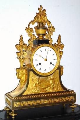 C.1820, French, Ormolu Clock with original dome and base, case depicts a goddess receiving grapes from a cherub, and swags of grape vine with clusters of grapes, all "growing" out of an urn at top.. — Antique Clocks Price Guide