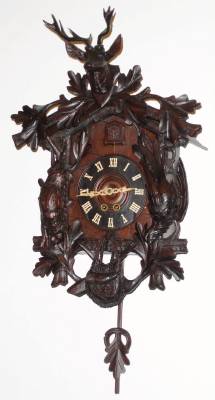 C.1900, German, Black Forest Cuckoo, Hunter Motif, with large and good carvings of a deer head, pheasant and rabbit, the substantial and robust movement of 8-day duration, uncommon spring driven (note winding arbors at 5+7). — Antique Clocks Price Guide