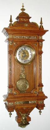 C.1903, (dated) German, Gustav Becker, Ornate Wall clock, oak case with 30 bits of cast brass decorations, and with fancy cast pendulum, serial 1,259,120, presentation piece. — Antique Clocks Price Guide
